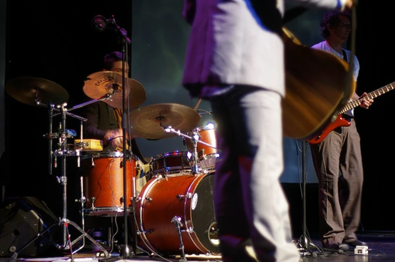 a group of musicians stand on stage with instruments