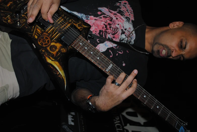 a man playing the guitar in front of a microphone