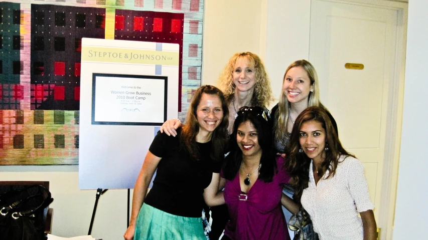 seven female friends posing for a po