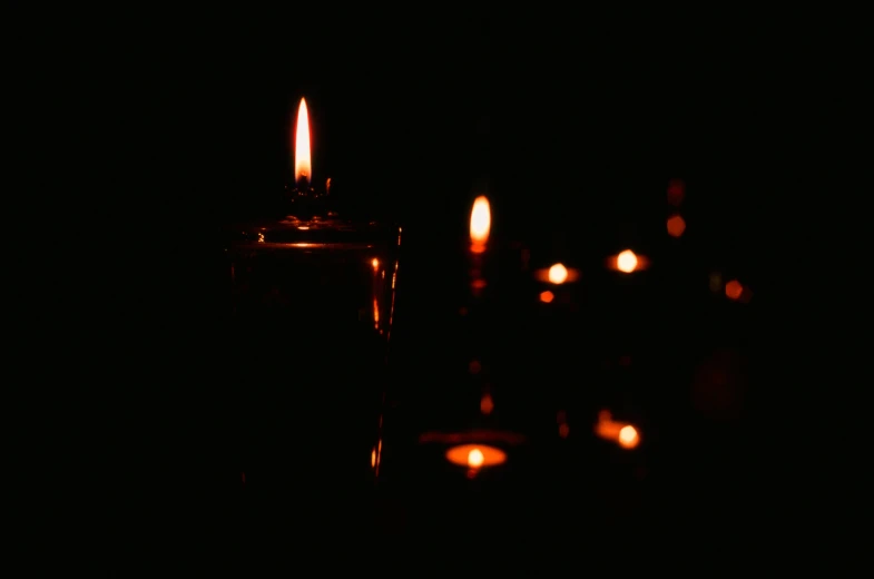candles are glowing in the dark and on the dark
