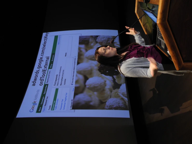 a woman is making a presentation at a lecture