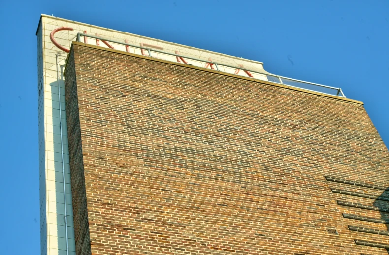 a very tall brick building next to a green traffic light