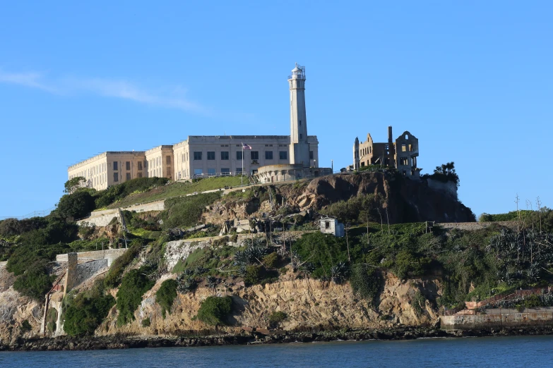 an old, historic building on a hill by the water