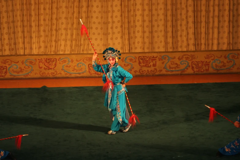 a woman in blue dress holding a red flag