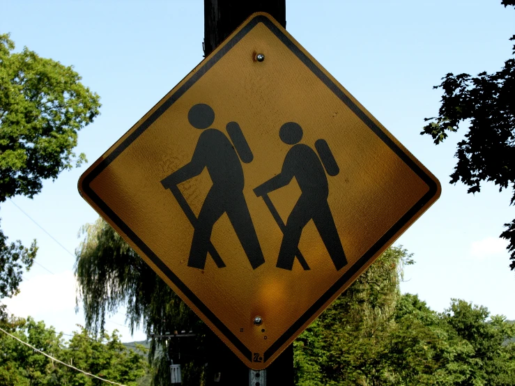 this yellow sign is about cross the street