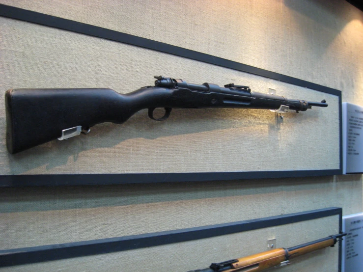 two display cases displaying weapons like rifles