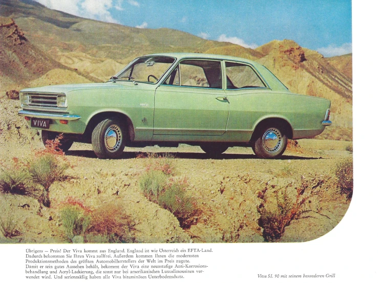 a green car parked on top of a grass covered field