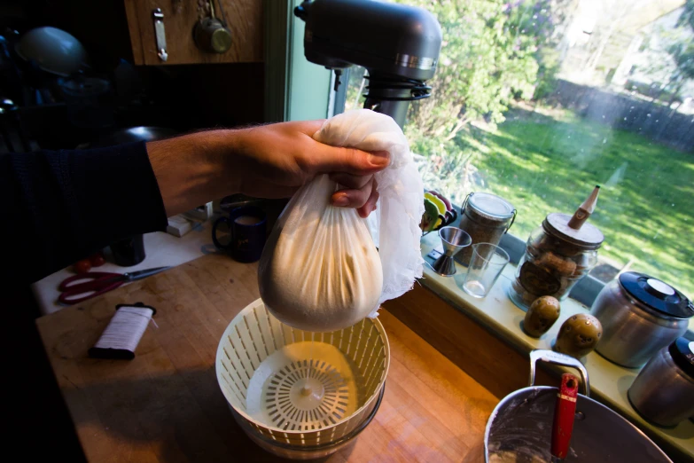 a person using a kitchen mixer to make soing out of garbage