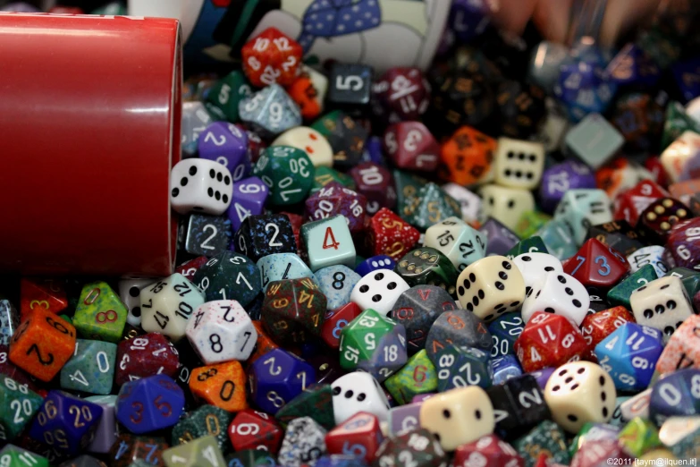 many different colored dice with numbers on them