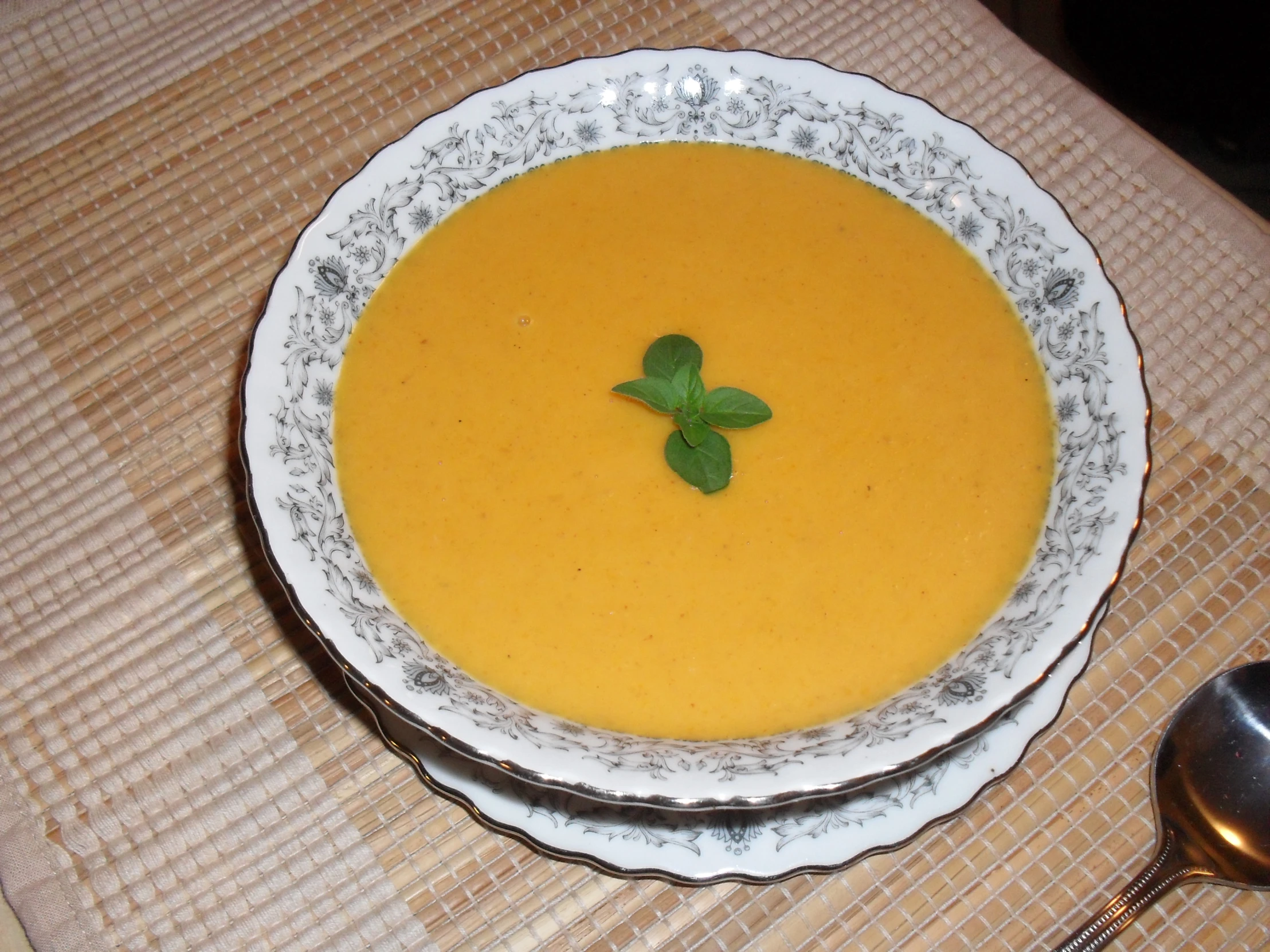 this is a bowl of soup with spoons