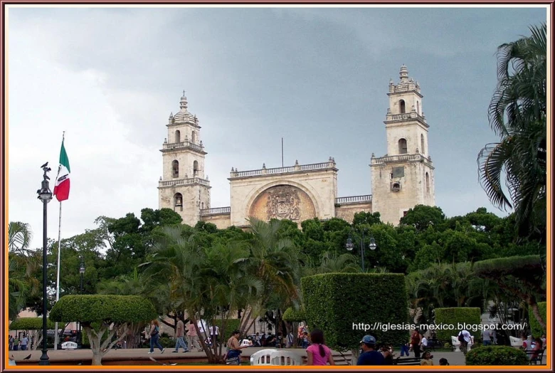 the tall white building has a cross at its center