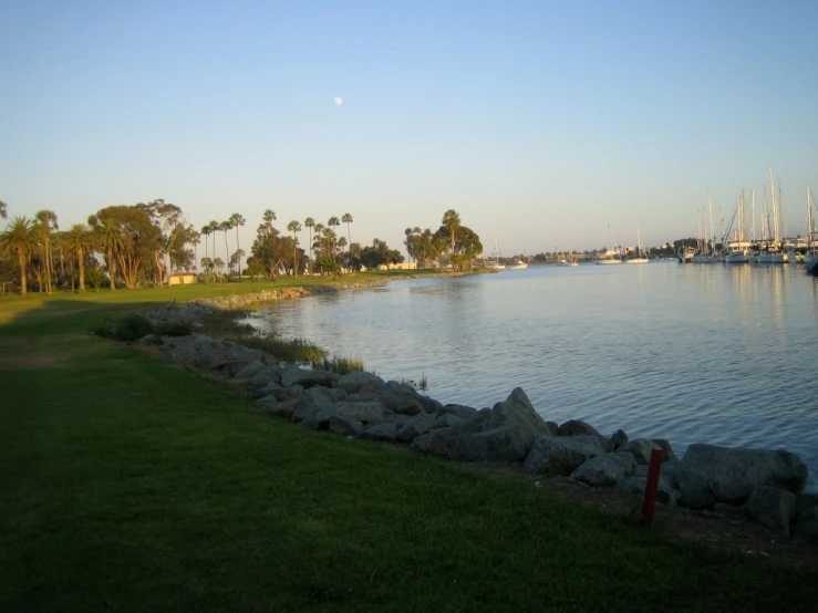 the view of a lake and a grassy area in the middle