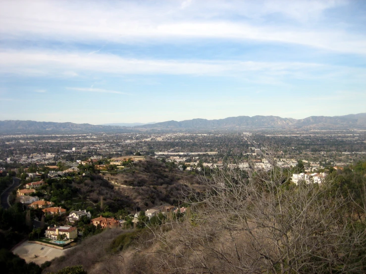 an aerial view of a city, with some mountains in the distance