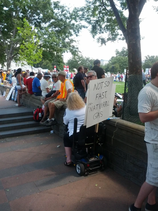 people sitting on a brick wall at an event