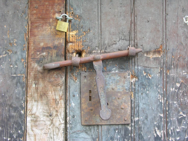 the old door with a lock has a latch