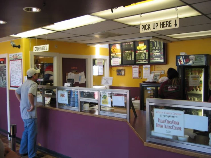 a man leaning against the edge of a counter