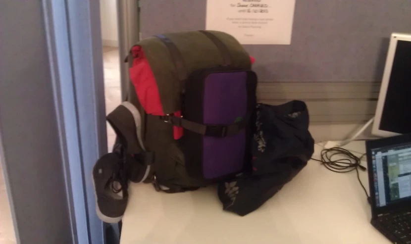 the back pack is sitting in front of the laptop