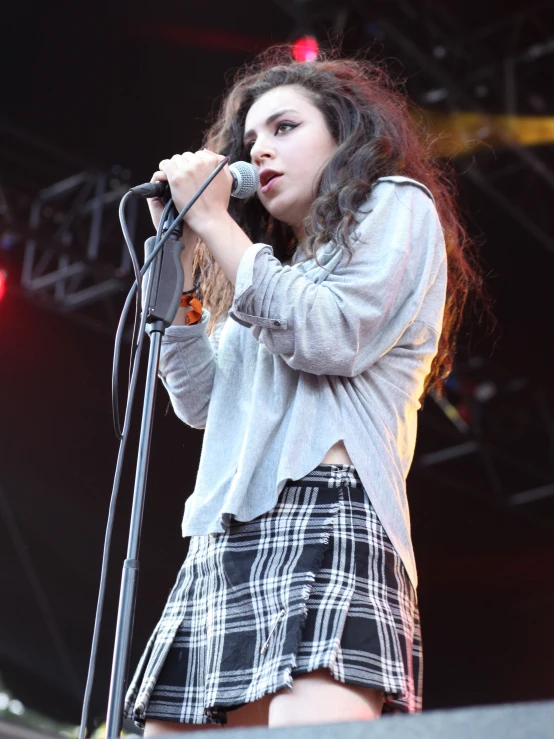 a woman that is standing in front of a microphone