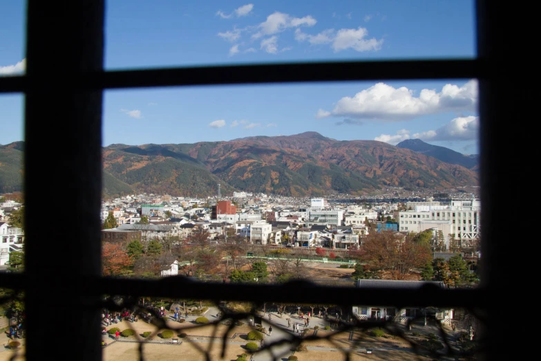 a window view of a town and mountains