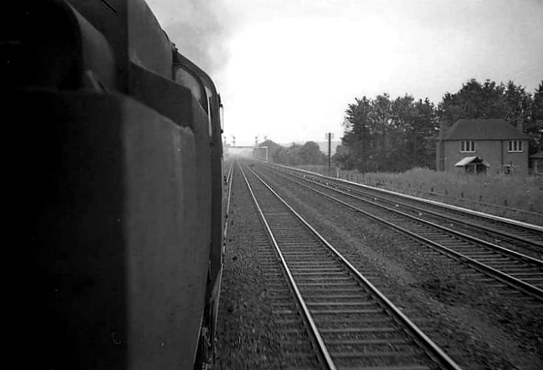 a train traveling down tracks next to trees