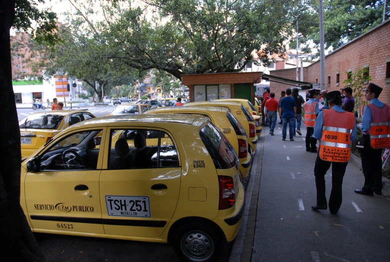 a car on the road with people walking around