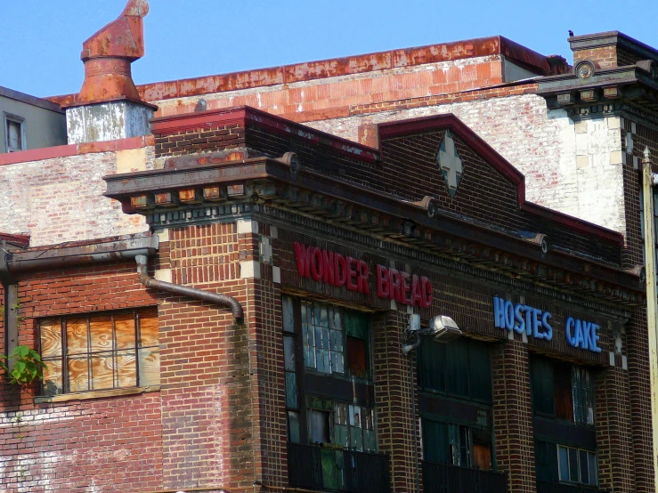 an old red brick building with windows and a sign on it