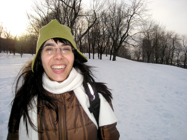 a woman wearing a jacket and a green hat