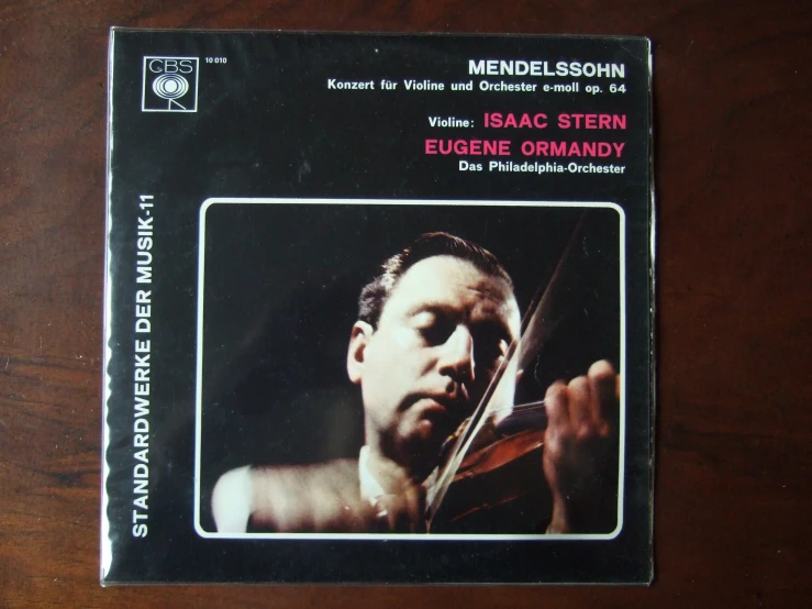 an album cover for an album with a man playing the violin