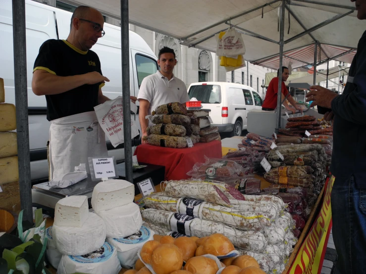 two men at a street market selling bread