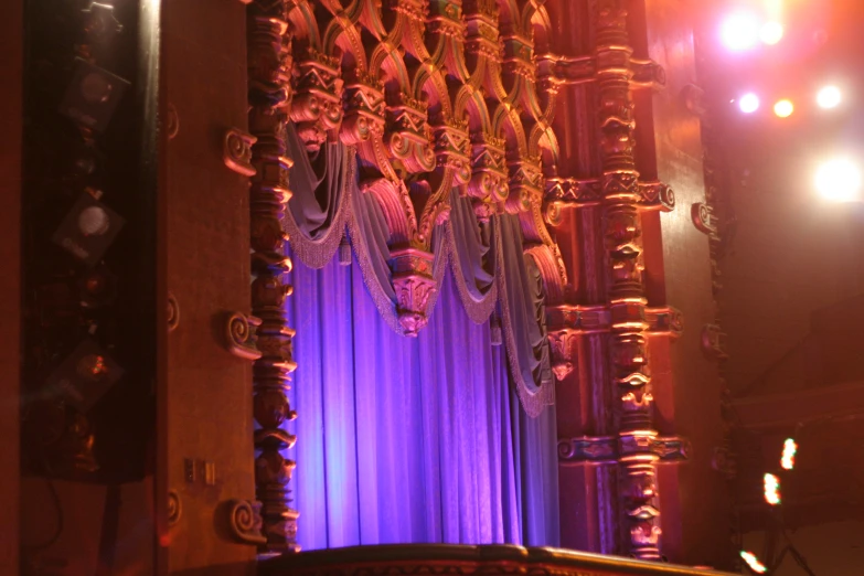 curtain with fringe on stage with chandelier at night