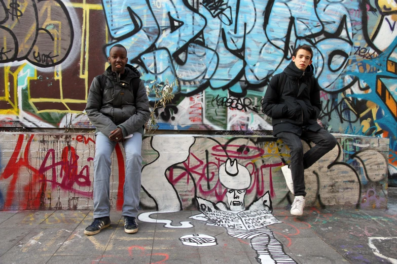 a couple of guys that are sitting on a wall