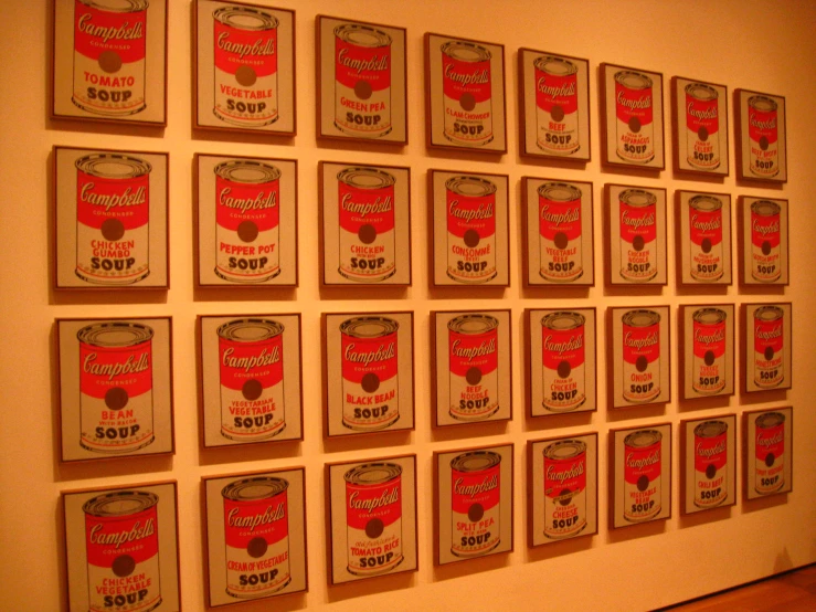 several framed, vintage campbell campbell canned cans hang on the wall