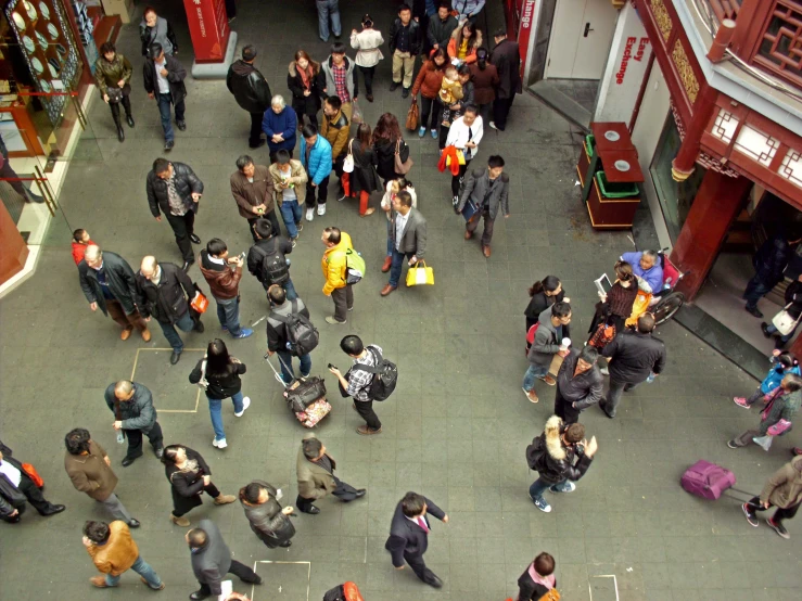 many people are waiting in an oriental mall