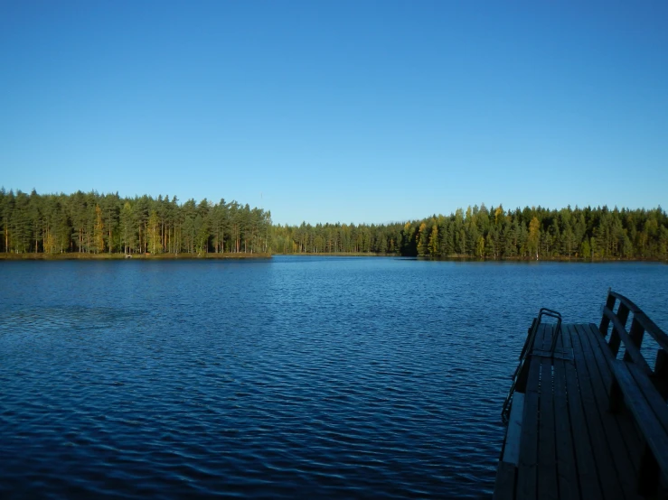 a long wooden pier stretches over a large body of water
