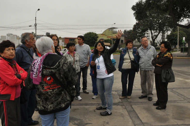 several people are standing on the side walk