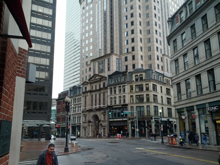 a guy walking down a deserted city street