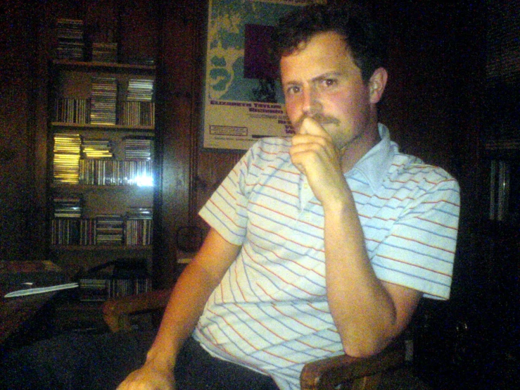 a man in a blue shirt smoking a cigarette