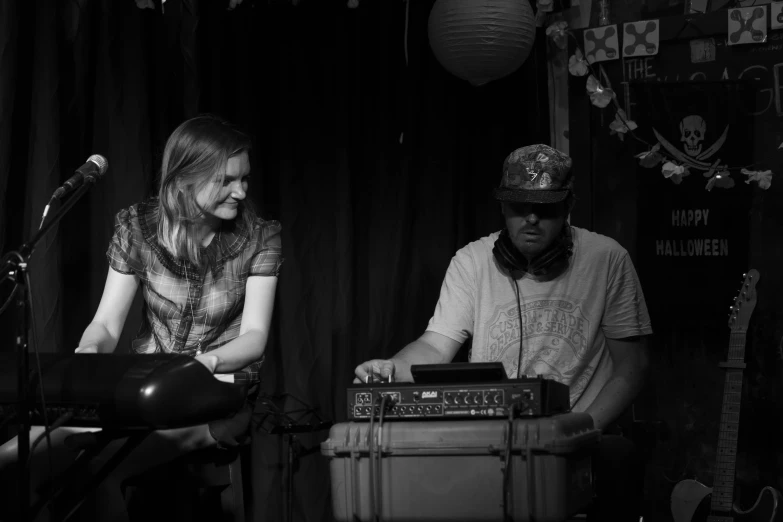 the man and woman are at a musical instrument