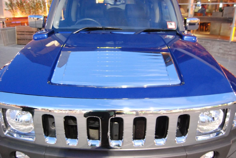 a blue jeep truck is sitting on the street