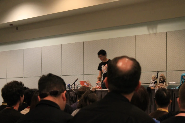 a man speaking to a large group of people