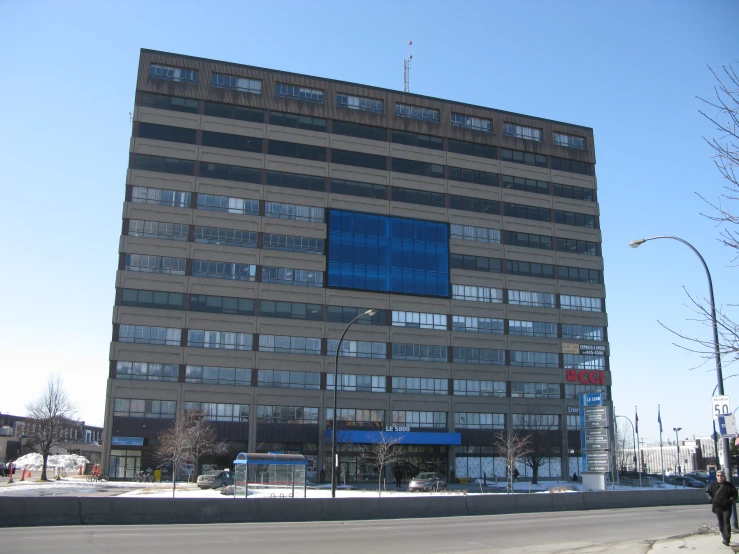 a building with lots of windows sitting on the side of a street