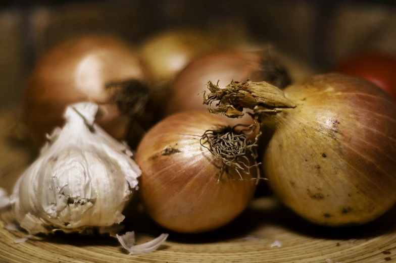 closeup of onions on a plate with their tops showing