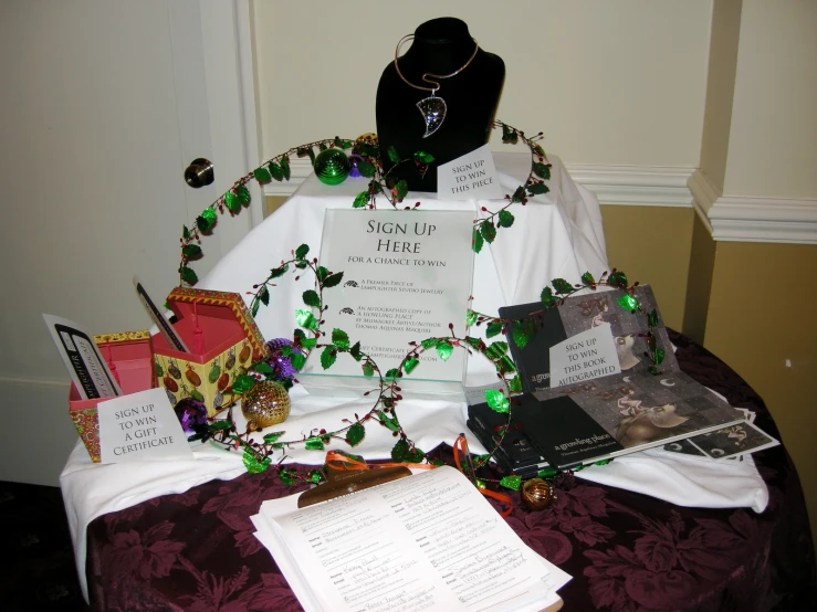 a display with a necklace and various items