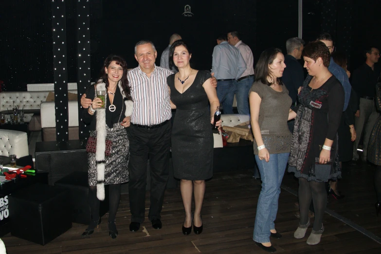 two women and an older man with their party guests