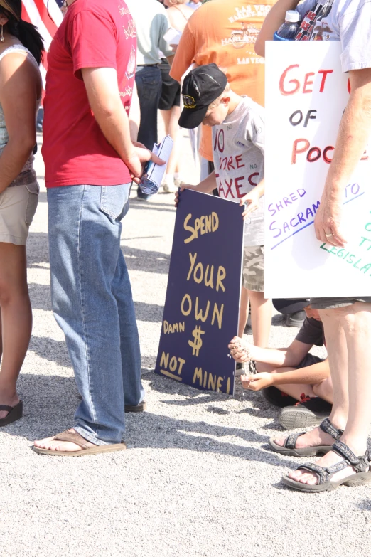 a group of people standing in the street with a sign