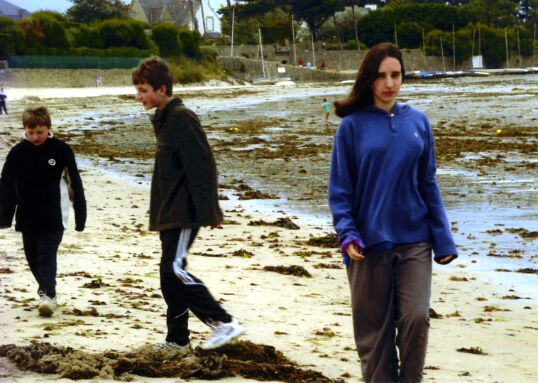 a family walking on the beach during the day