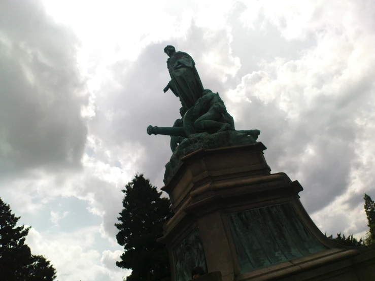 a statue of a man on horseback near trees