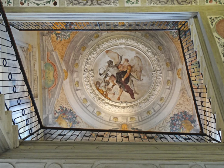 a ceiling in the middle of a church with many paintings on it