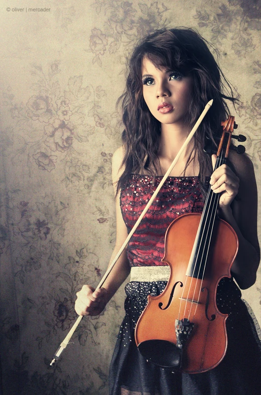 a girl holding her violin in one hand