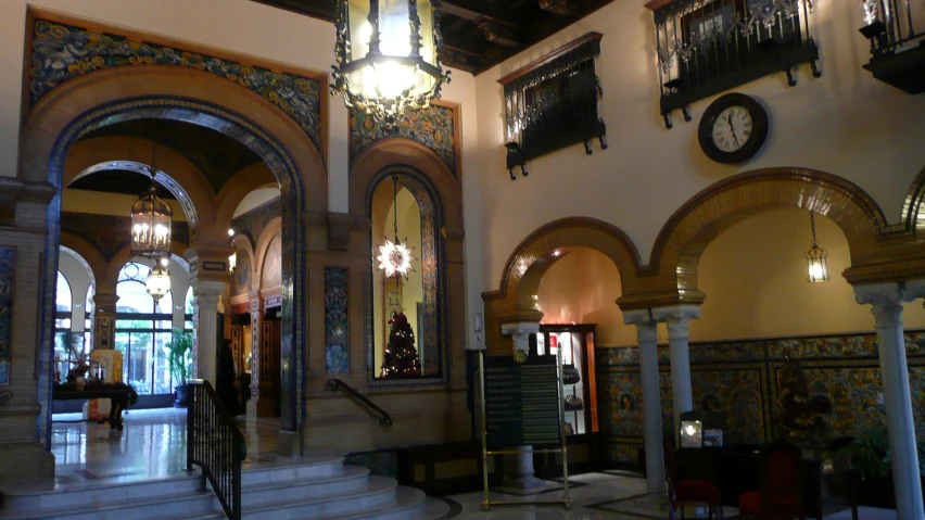 a room with several pillars and chandeliers inside of it